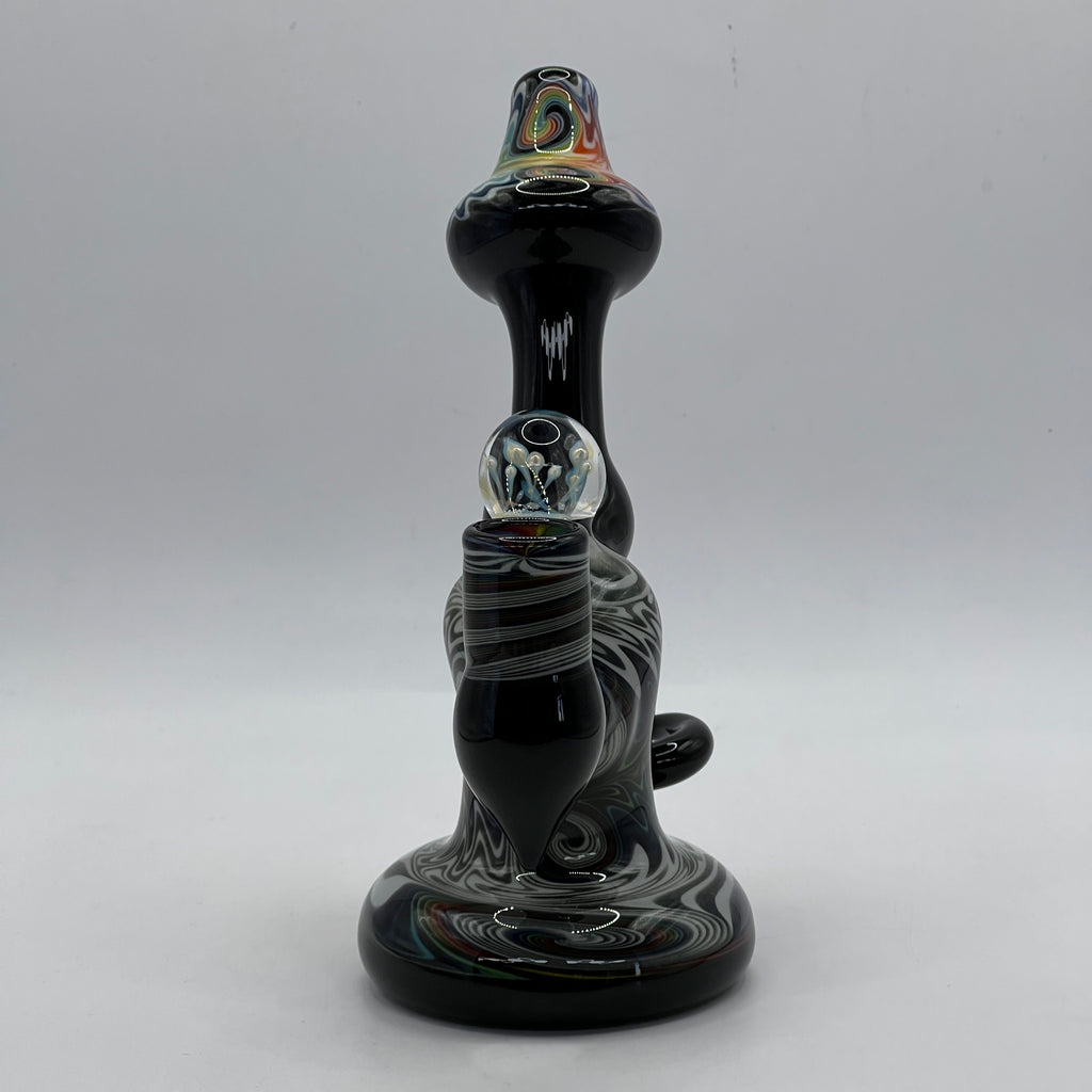 Front view highlighting rainbow mouthpiece and sculptural marbles