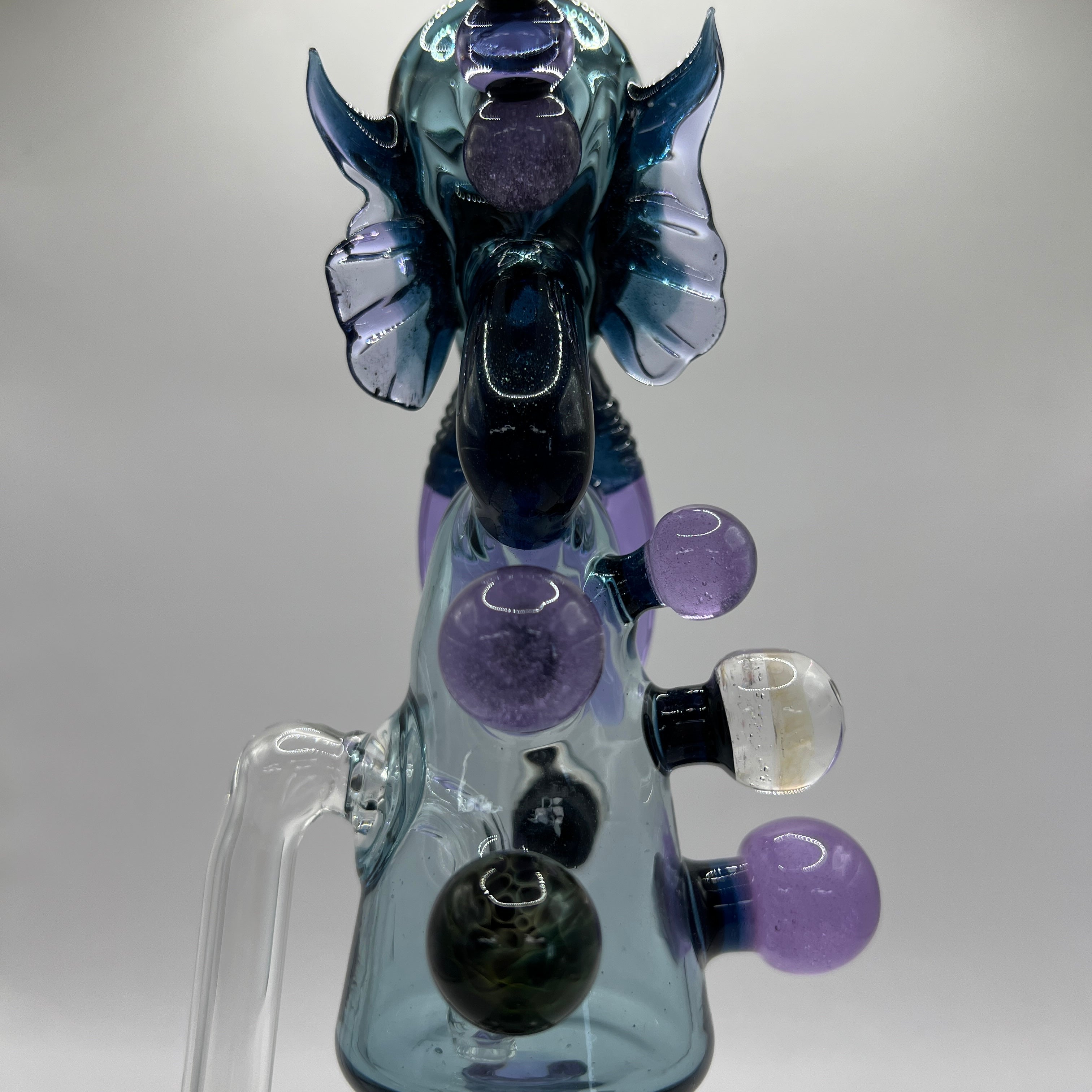 Detail view of sculpted purple tentacles and marble accents