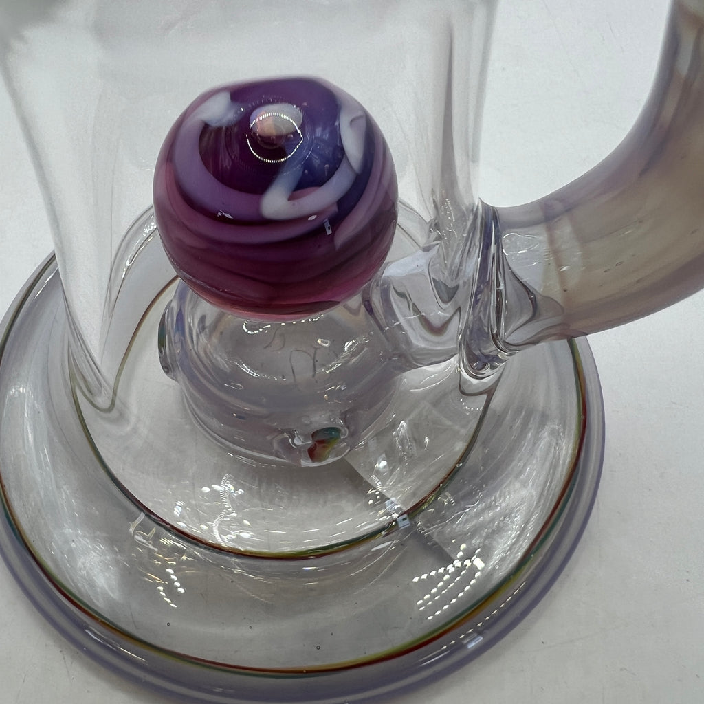 Close-up of floating purple vortex marble inside OM Glass rig