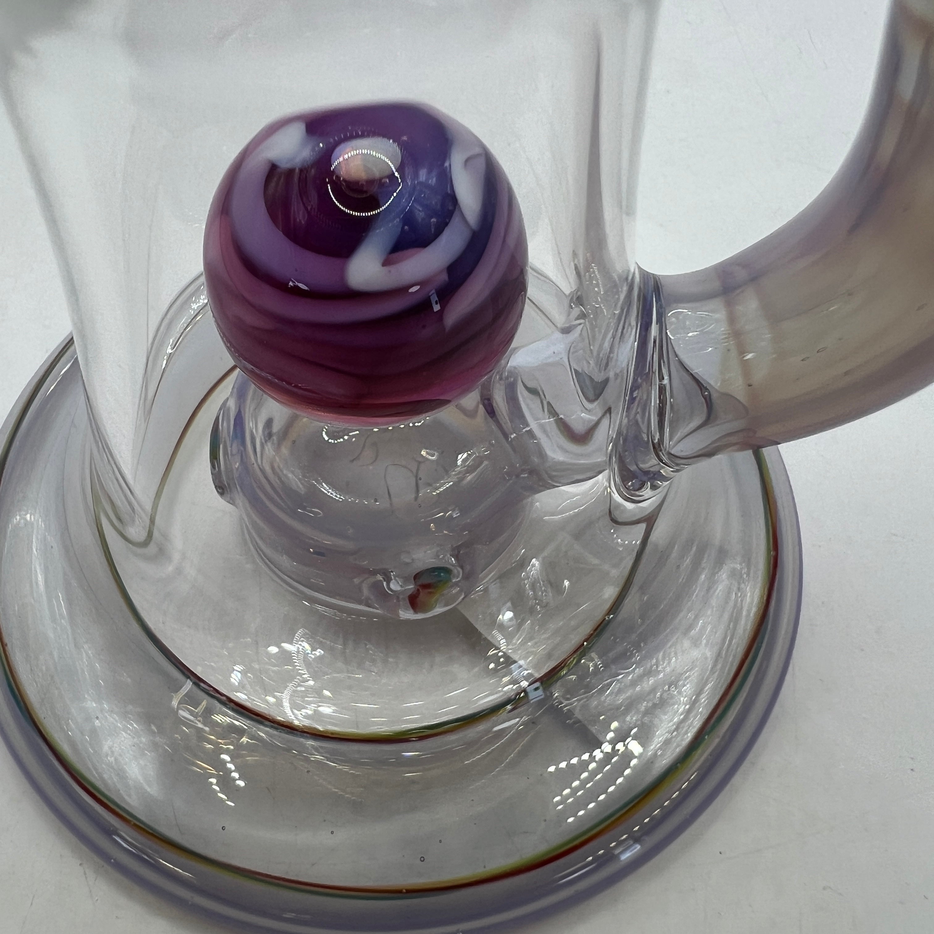 Close-up of floating purple vortex marble inside OM Glass rig
