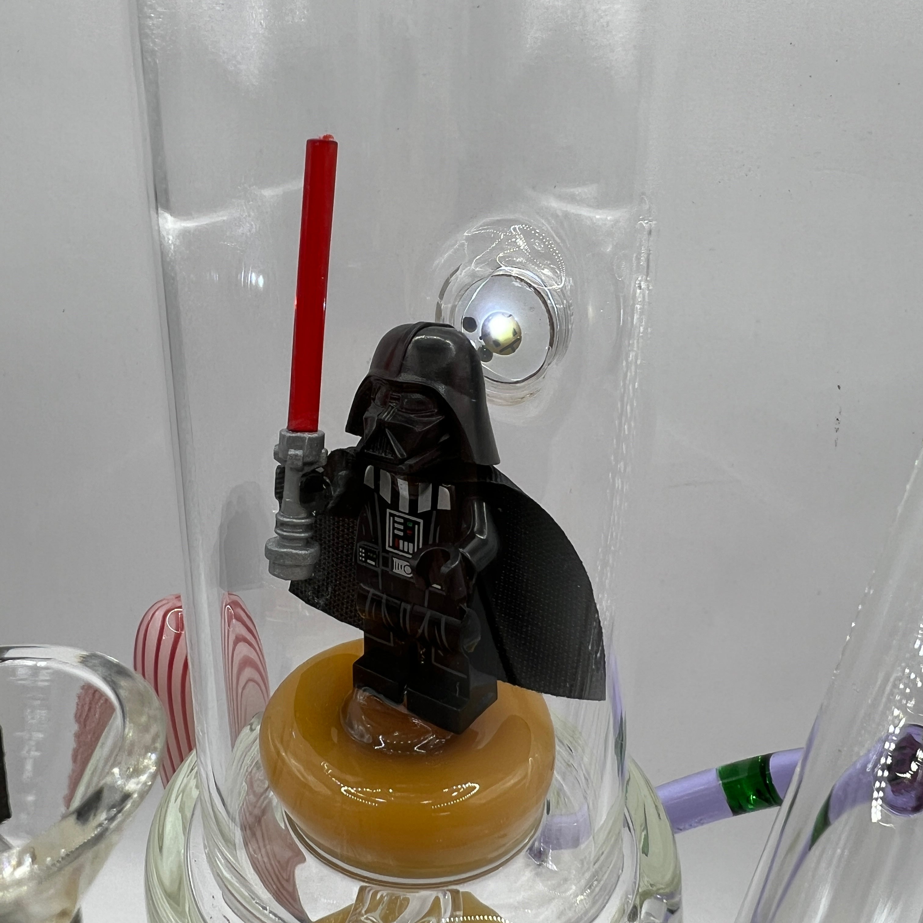 Close-up of Darth Vader inspired figurine inside illuminated display chamber
