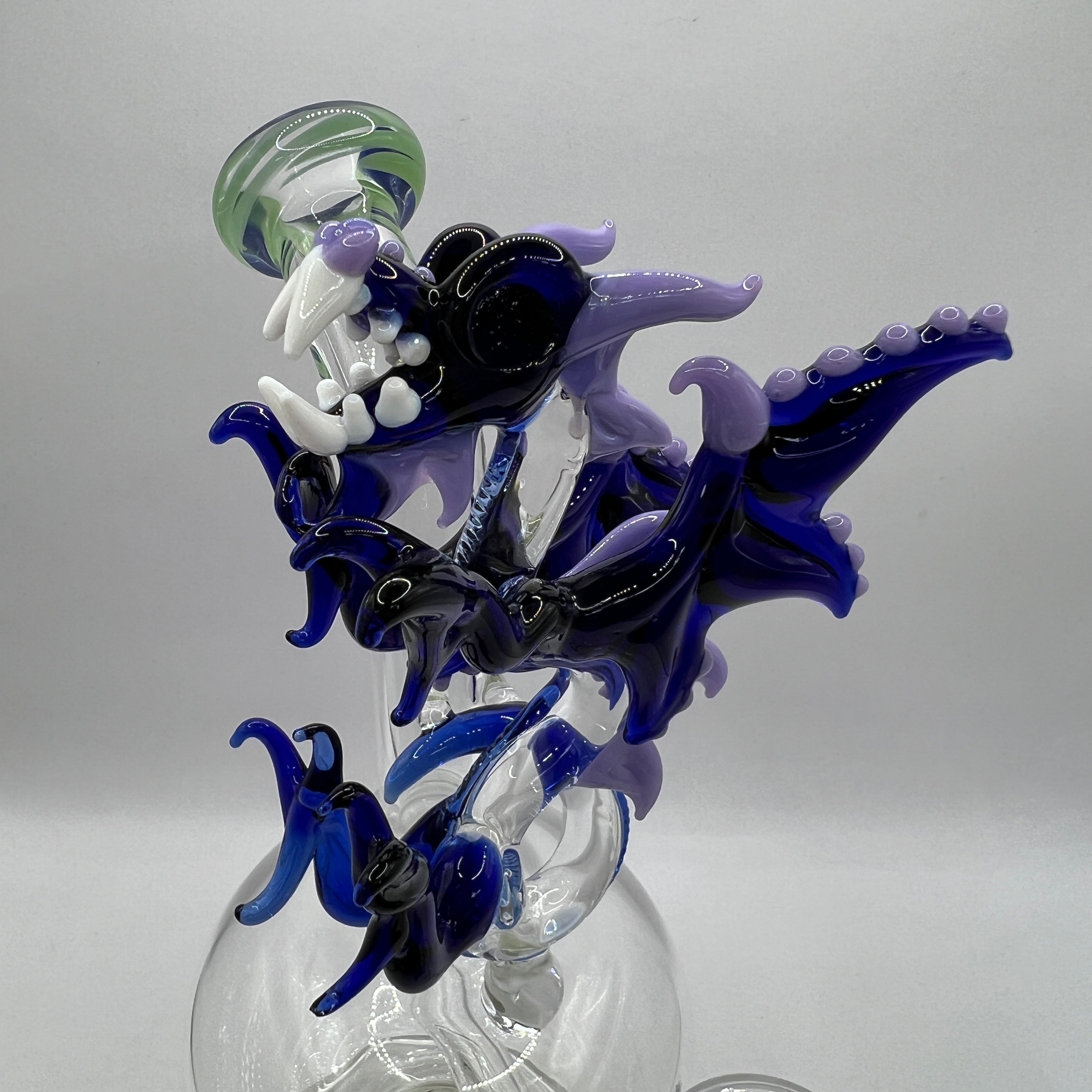 Detailed handcrafted dragon sculpture featuring wings, horns, scales, and fangs
