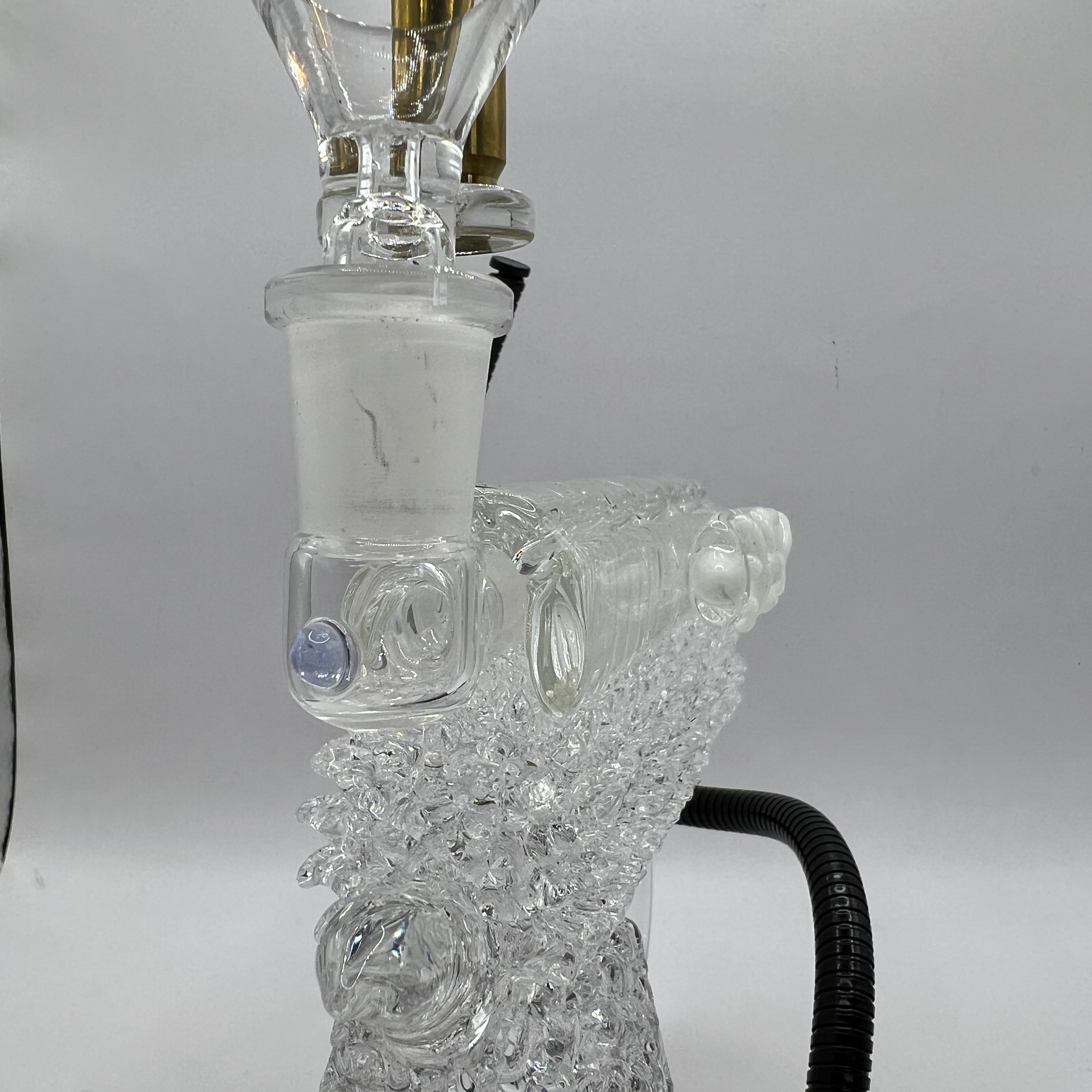 Detailed view of the textured glass grip and handcrafted chaos pattern on the OTG Glass collector handgun pipe.