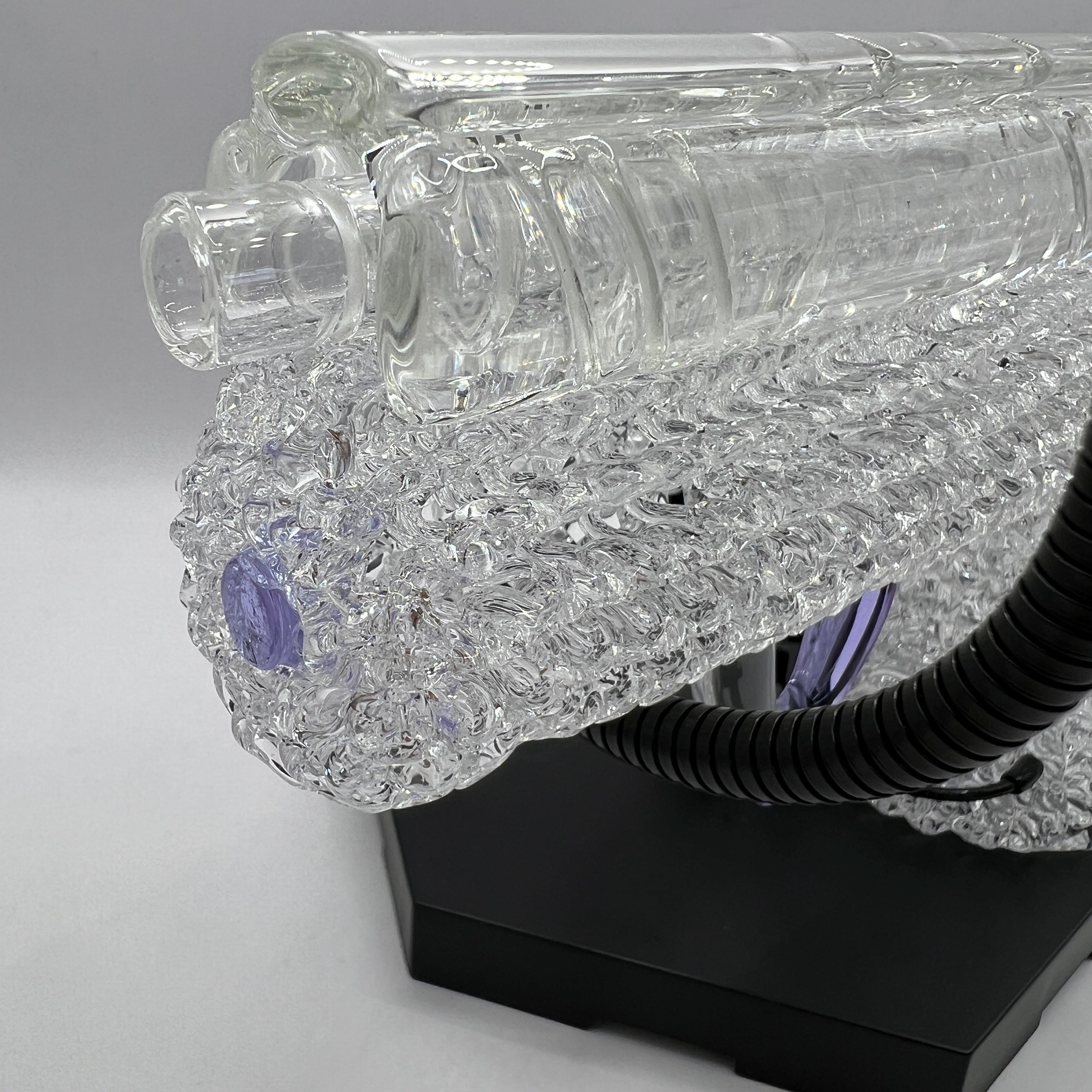 Close-up of the sculpted slide and precision glass detailing on the OTG Glass .45 caliber handgun pipe.
