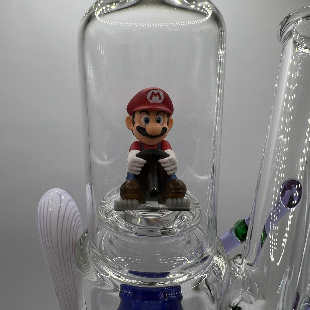 Close-up of Mario figurine inside the upper glass display chamber