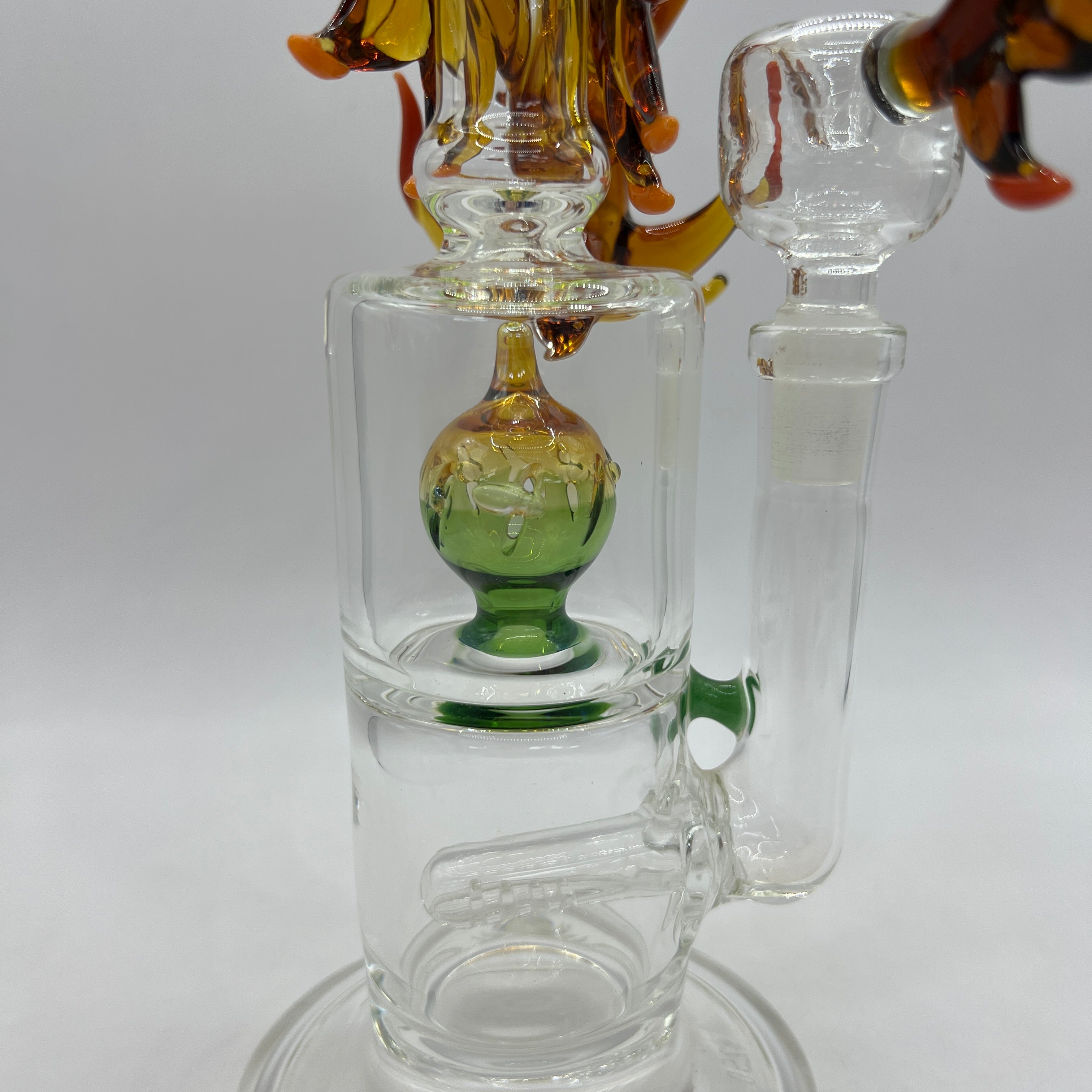 Close-up of green upper percolator inside handcrafted OTG Glass Phoenix water pipe