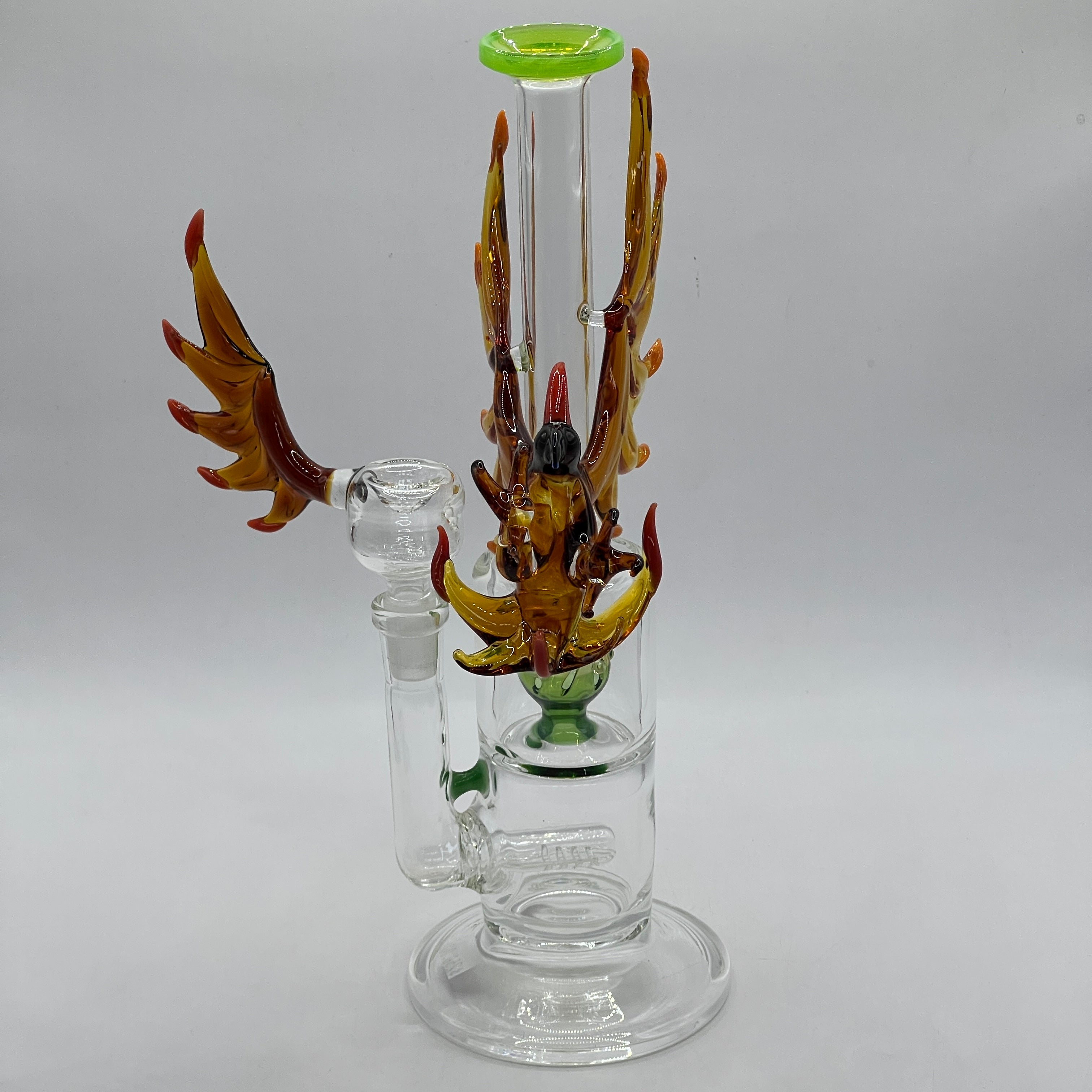 Side profile of handcrafted phoenix artwork wrapping around the neck of the water pipe