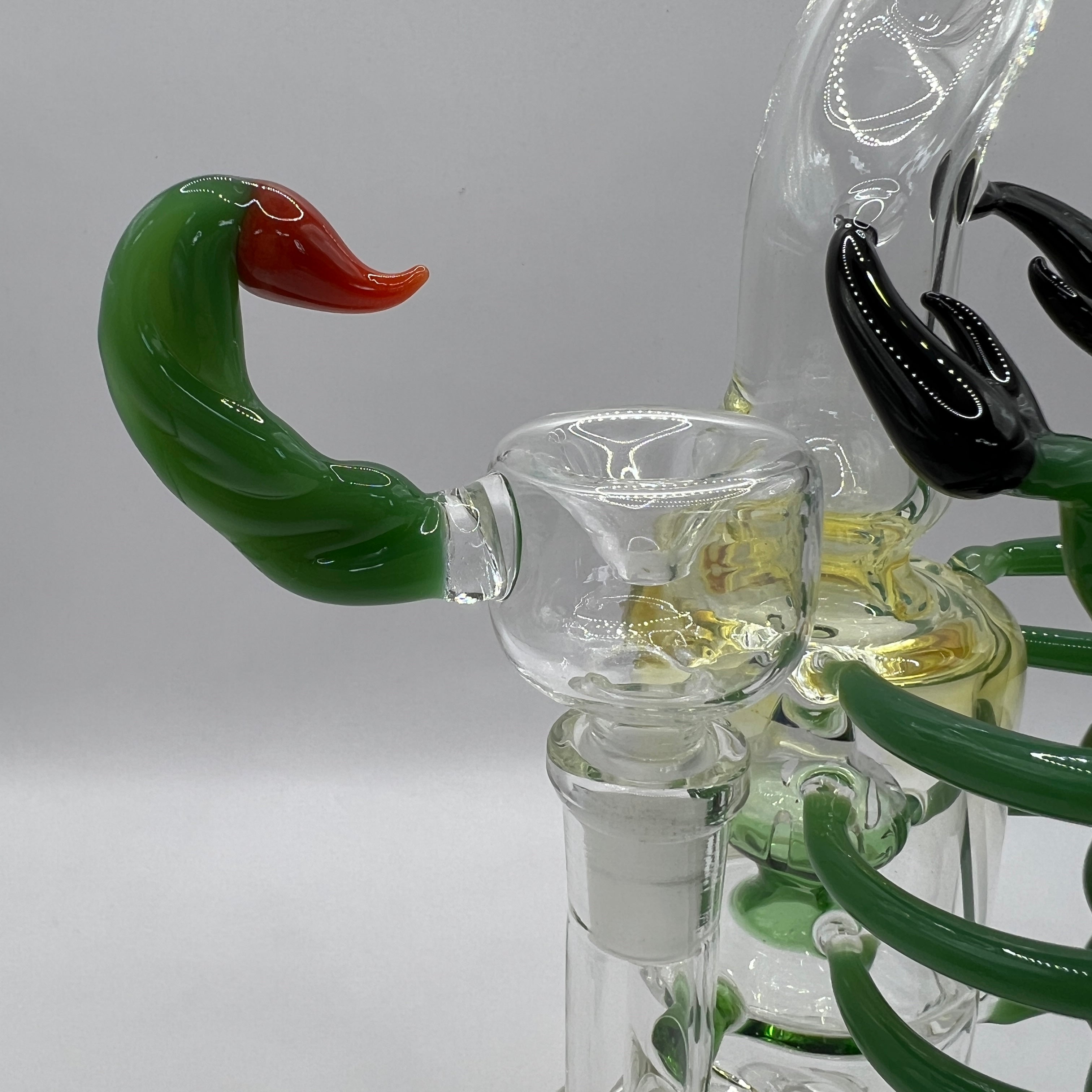 Close-up of matching green scorpion stinger bowl for OTG Glass water pipe