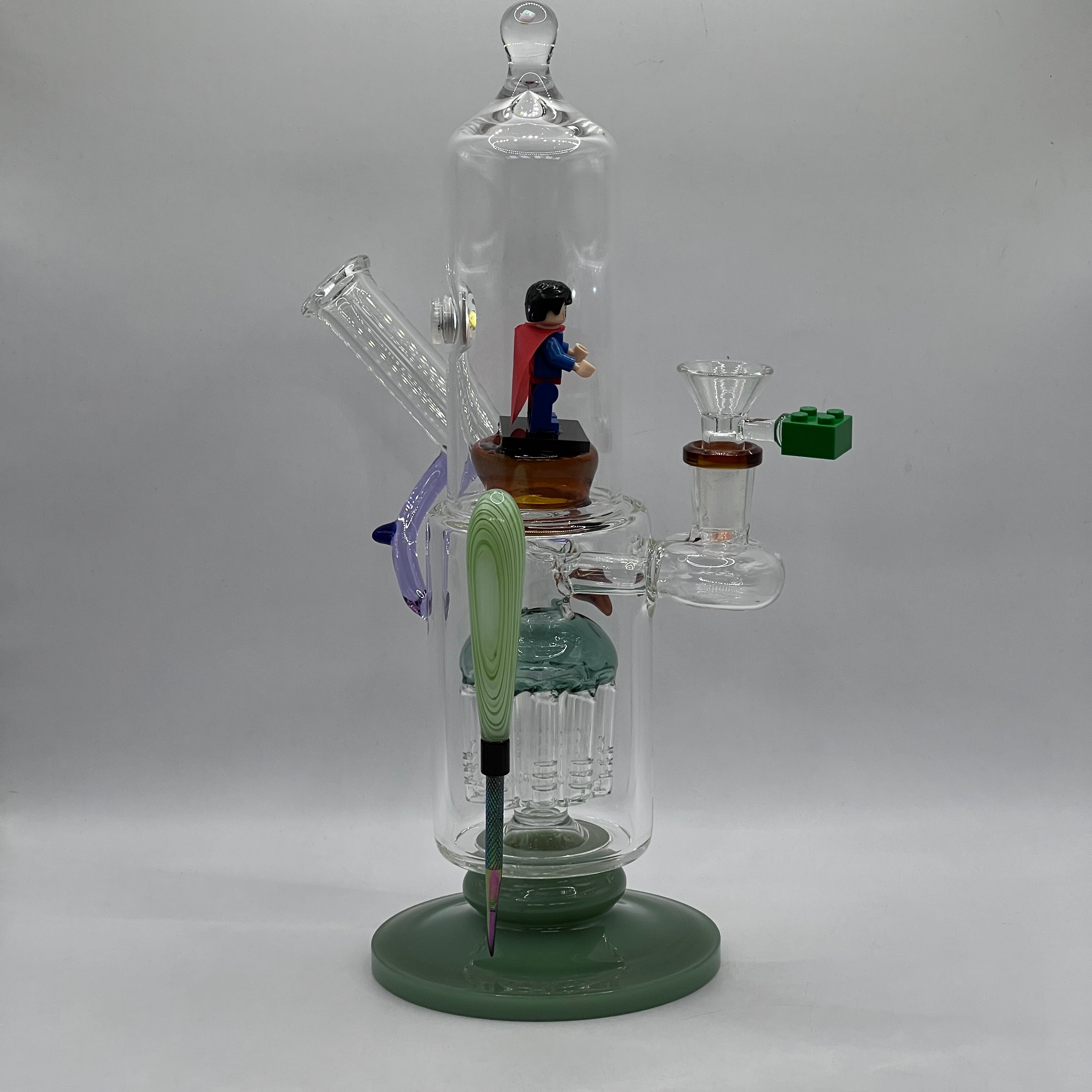 OTG Glass Superman themed water pipe with LED display chamber, tree percolator and magnetic tool.
