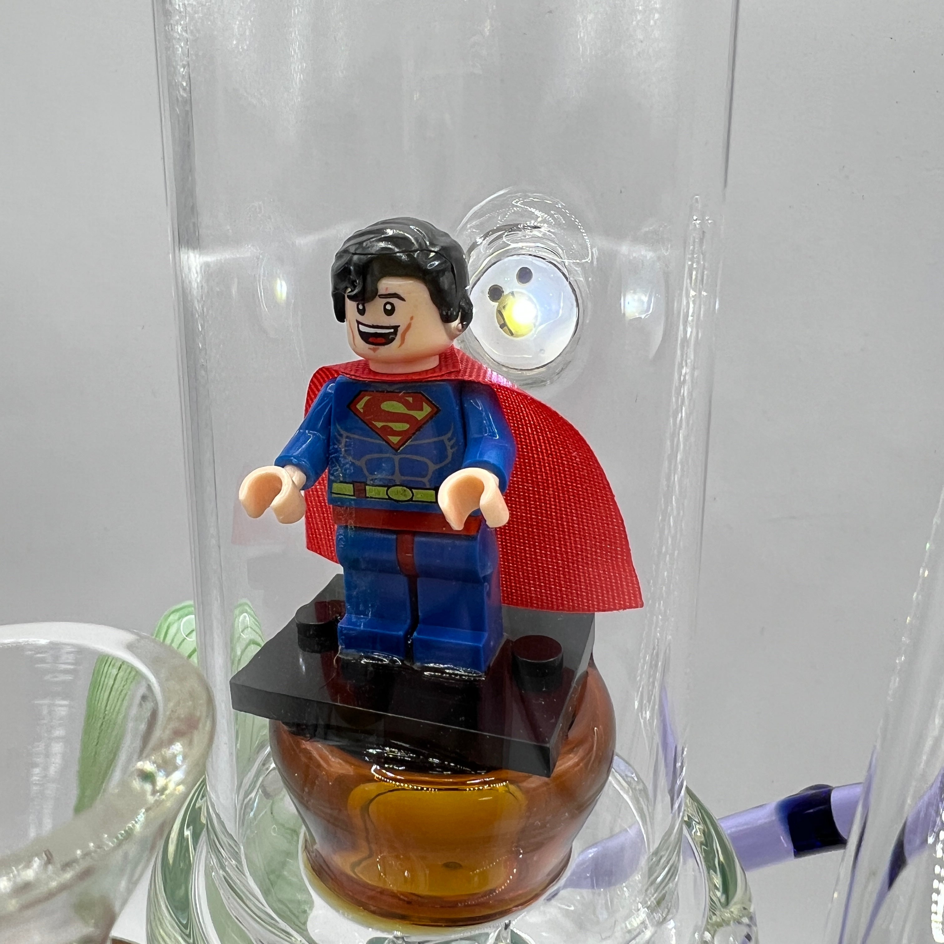 Detailed view of the Superman figurine centerpiece inside the premium glass display chamber.