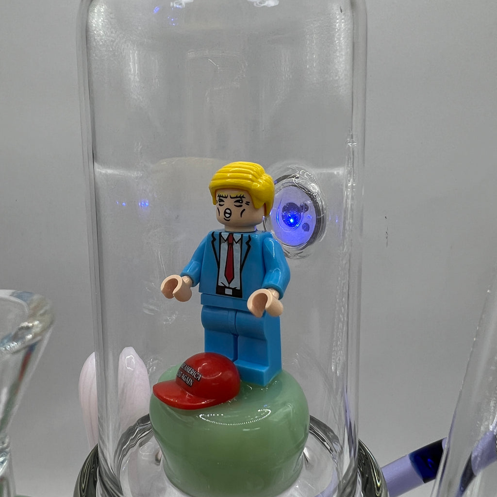 Close-up of enclosed Donald Trump inspired figurine with LED illumination