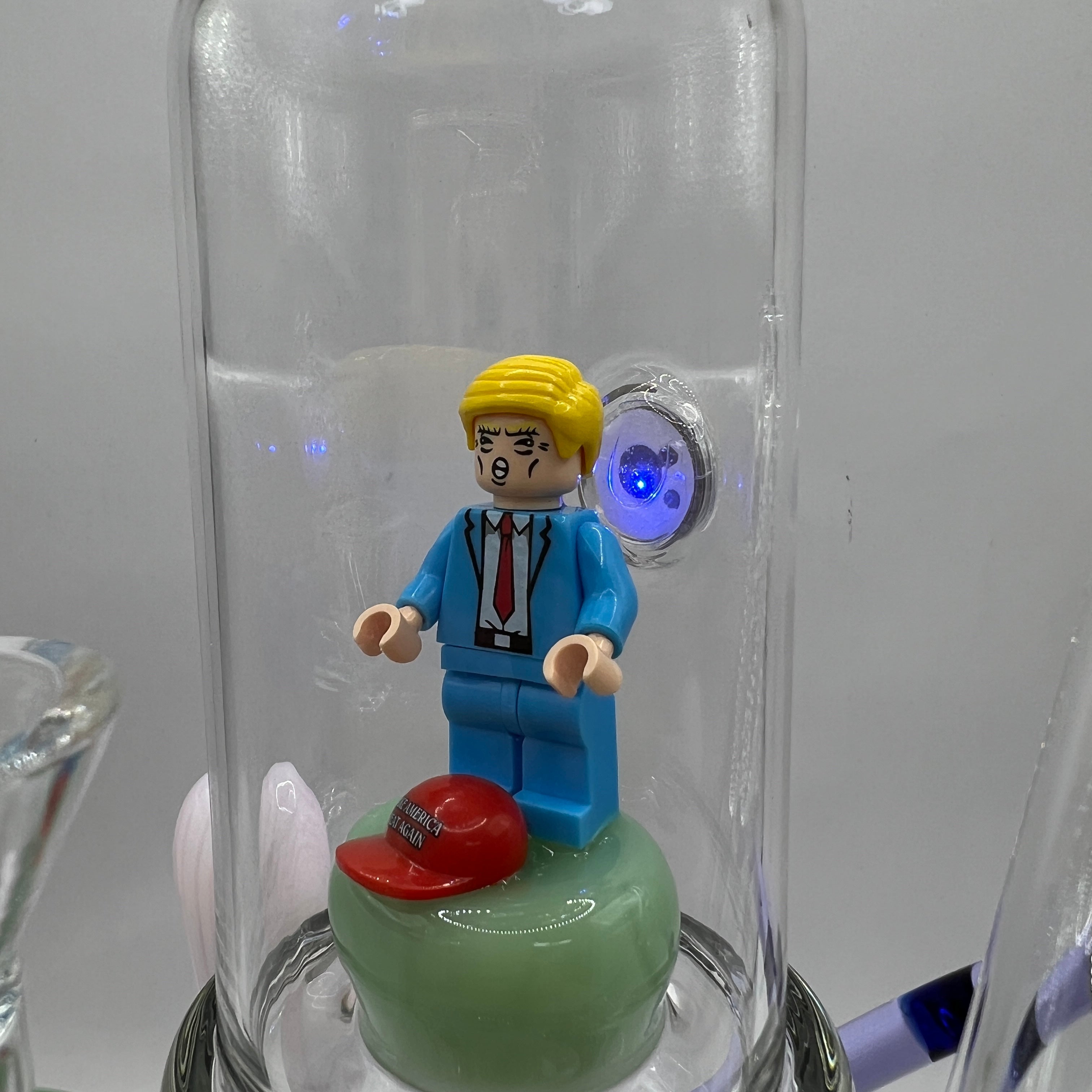 Close-up of enclosed Donald Trump inspired figurine with LED illumination