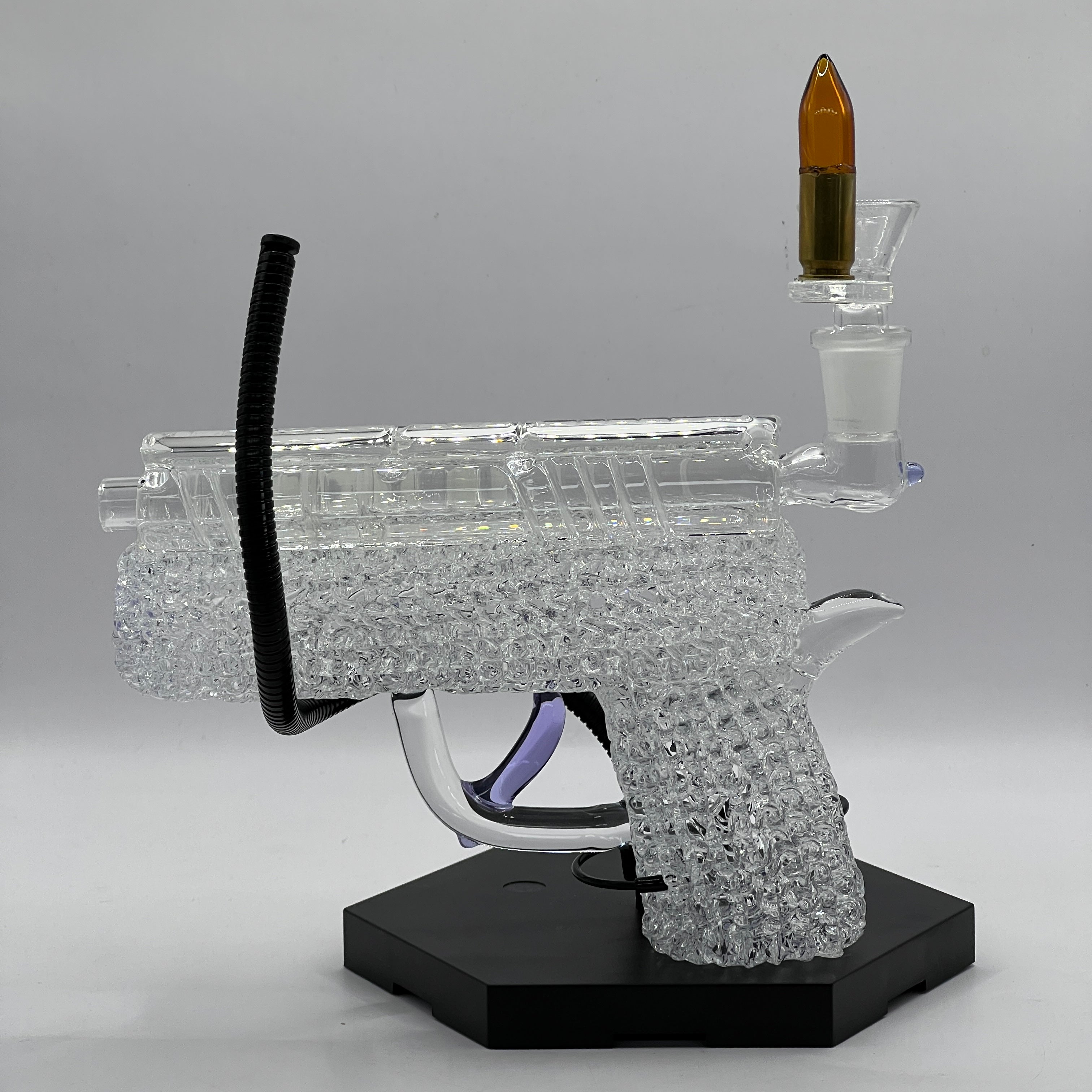 Side view of handcrafted OTG Glass .45 caliber handgun pipe with detailed slide, chaos texture, purple accents, and custom glass cartridge bowl.